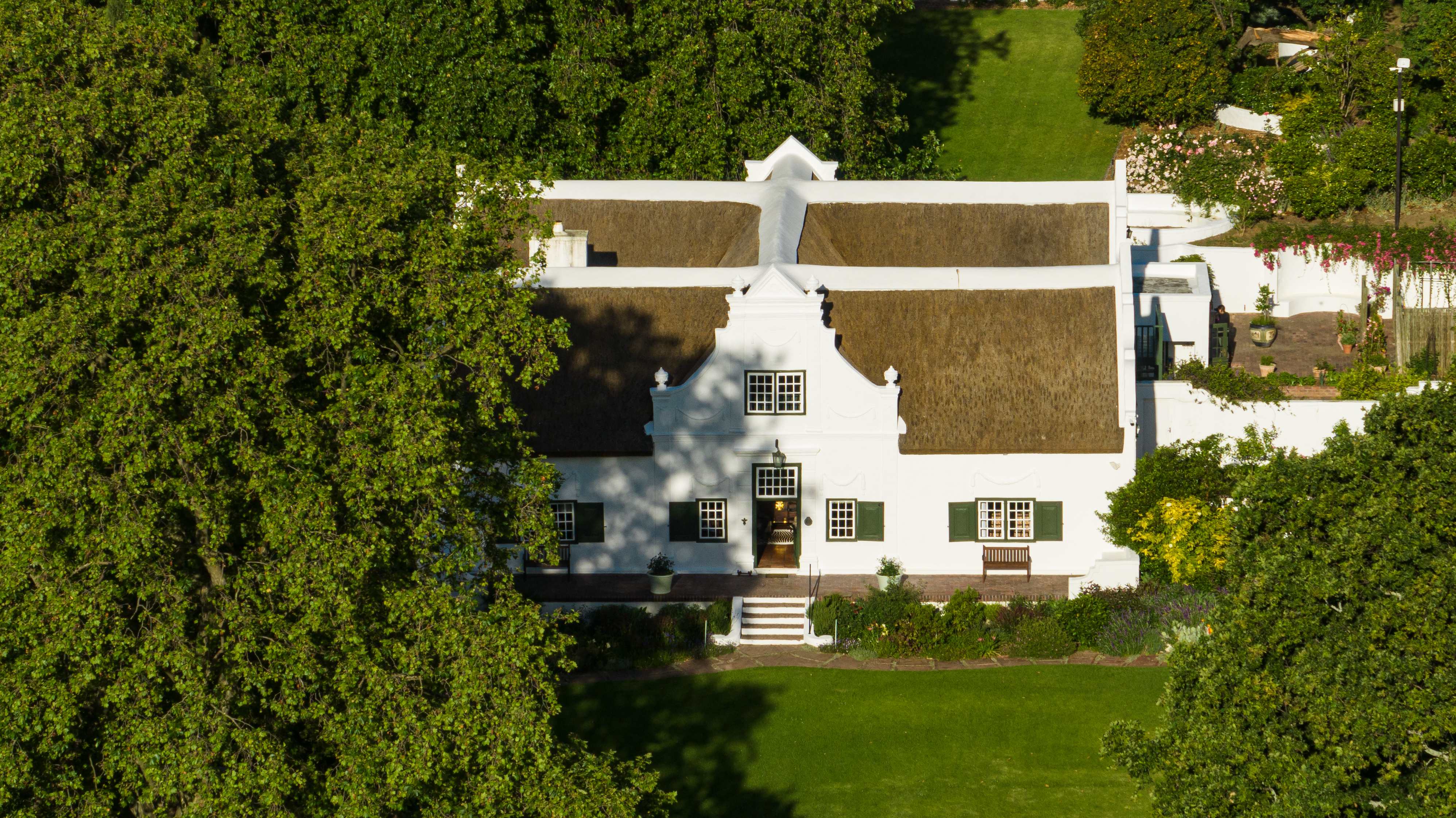 Aerial overhead view of Navarre Cape Dutch manor with thatched roof