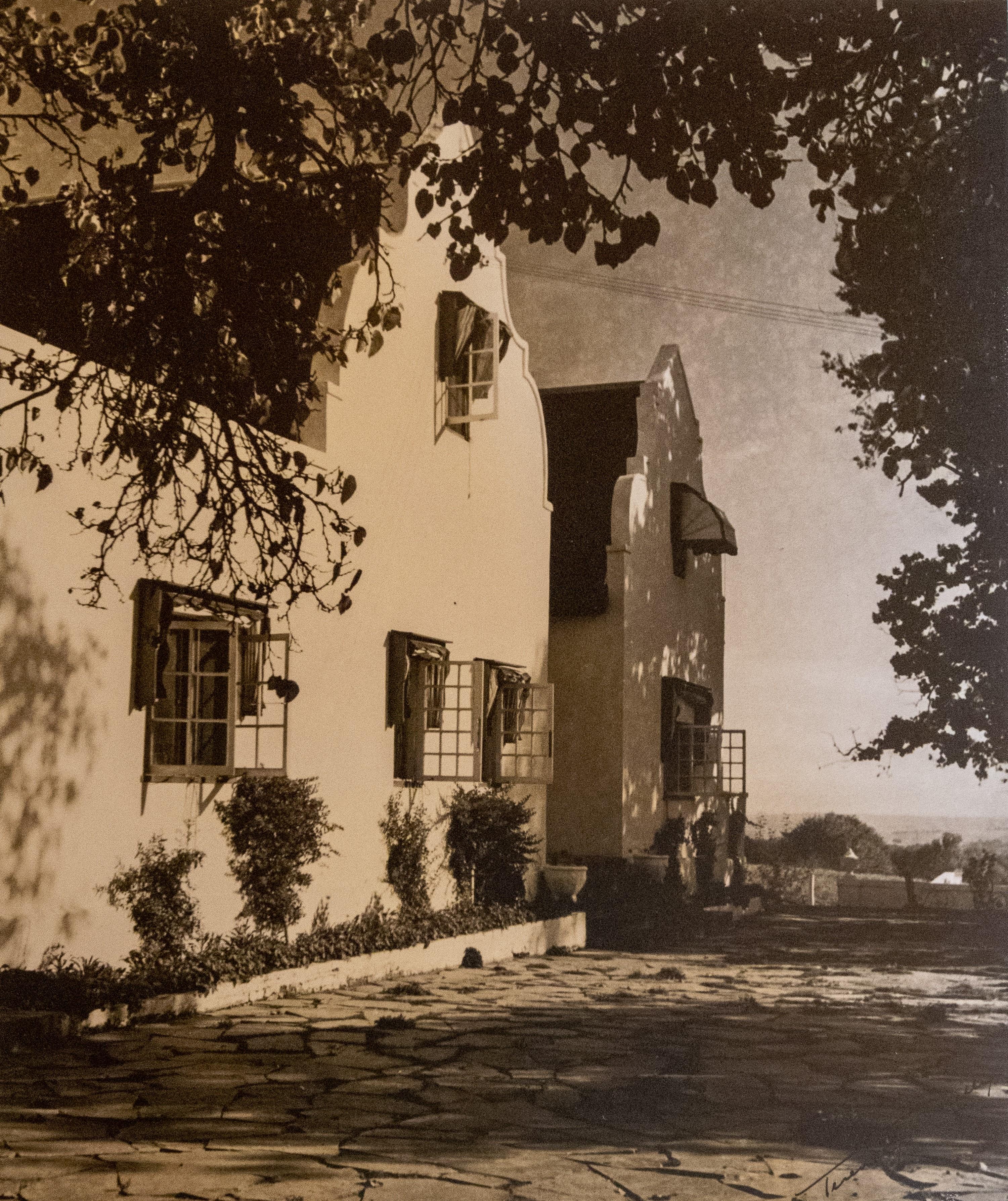 Vintage sepia photograph of Navarre manor facade with cobblestone path