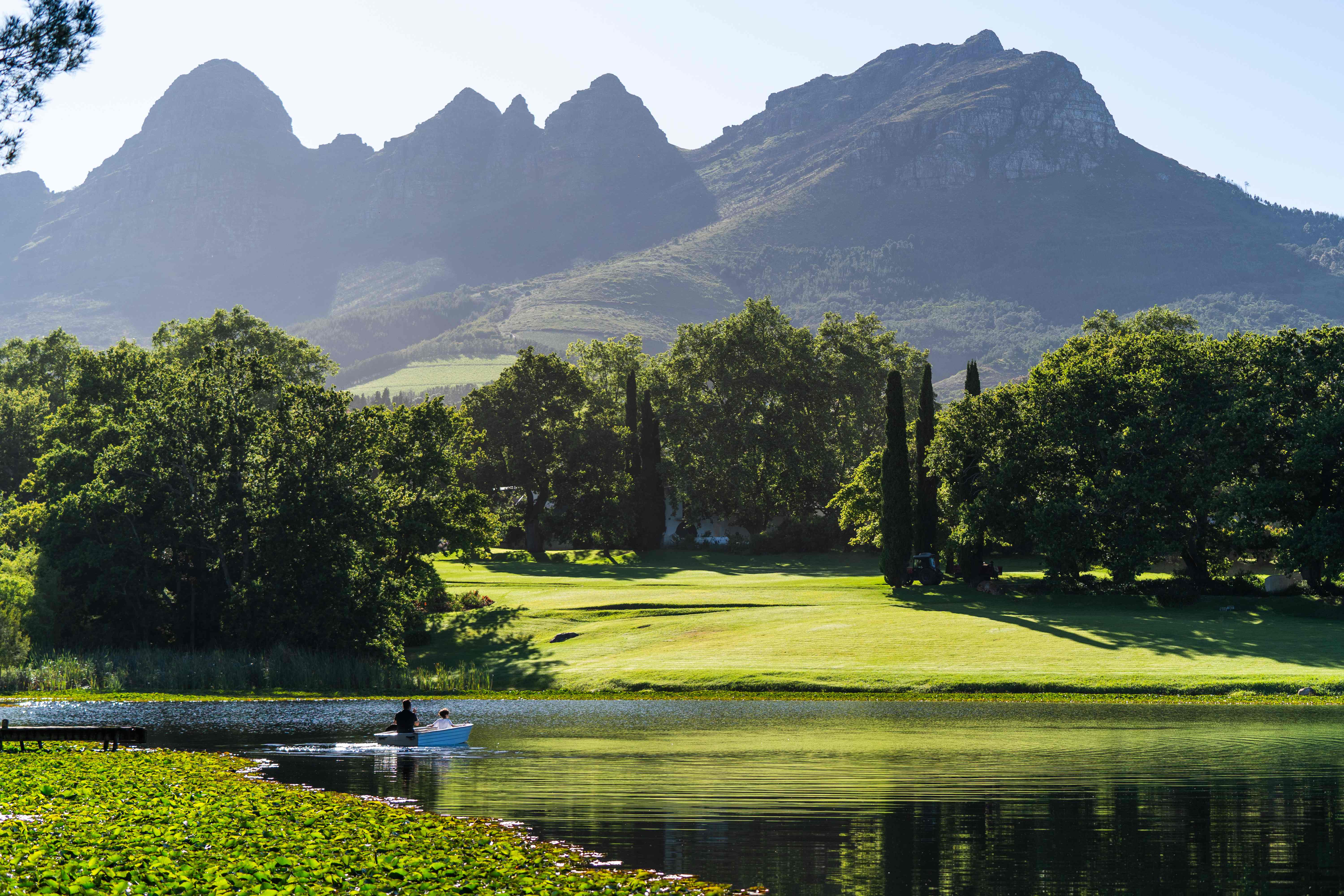 Lake with boat and Helderberg mountains at Navarre Residence